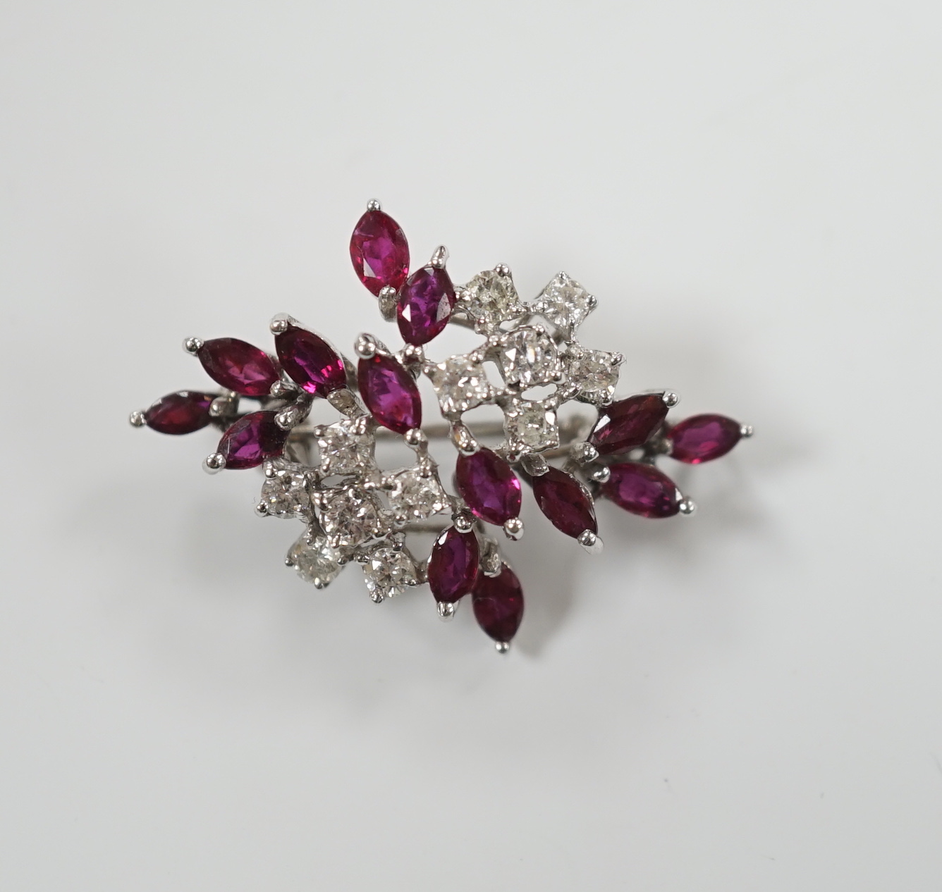 A modern white metal, ruby and diamond cluster set foliate spray pendant brooch, 32mm, gross weight 5.4 grams.